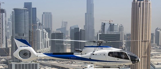 Helicopter Flying Above Dubai Skyline