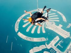 A man riding a parachute in the air in Dubai