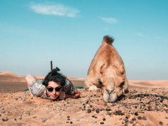 women next to camel at lahbab desert safari