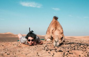women next to camel at lahbab desert safari