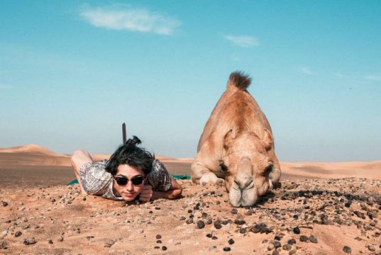 women next to camel at lahbab desert safari