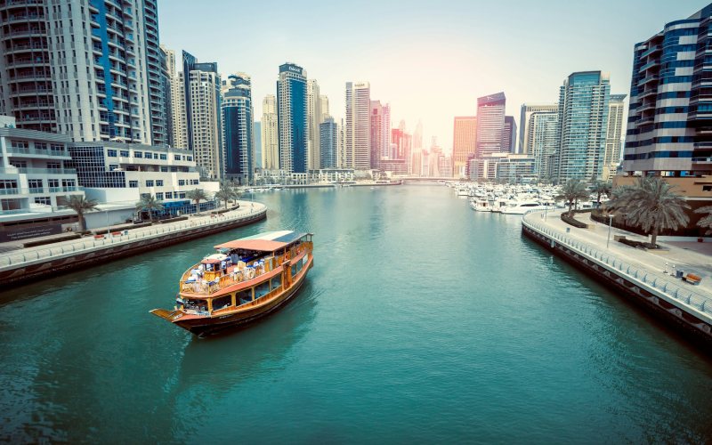 Brown boat on body of water in Dubai.