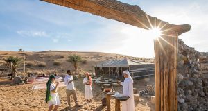 Guests enjoying a traditional welcome at a luxury desert safari camp.