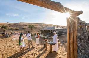 Guests enjoying a traditional welcome at a luxury desert safari camp.