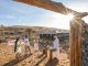 Guests enjoying a traditional welcome at a luxury desert safari camp.