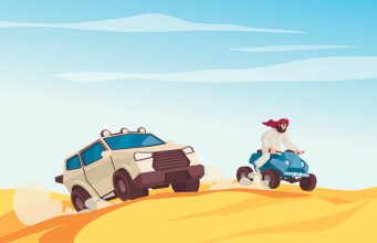 Man on quad bike and SUV driving over desert dunes.