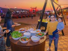 BBQ dinner in Dubai desert with a lady holding a baby