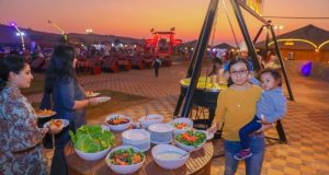 BBQ dinner in Dubai desert with a lady holding a baby
