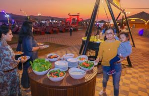 BBQ dinner in Dubai desert with a lady holding a baby