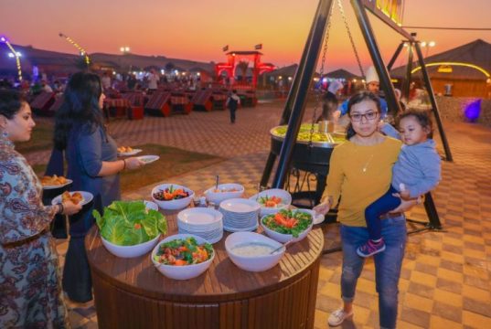BBQ dinner in Dubai desert with a lady holding a baby