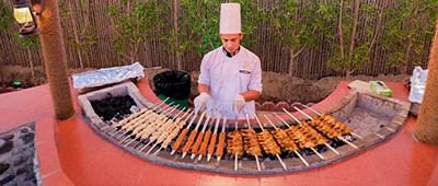 Man grilling dinner during Dubai desert safari