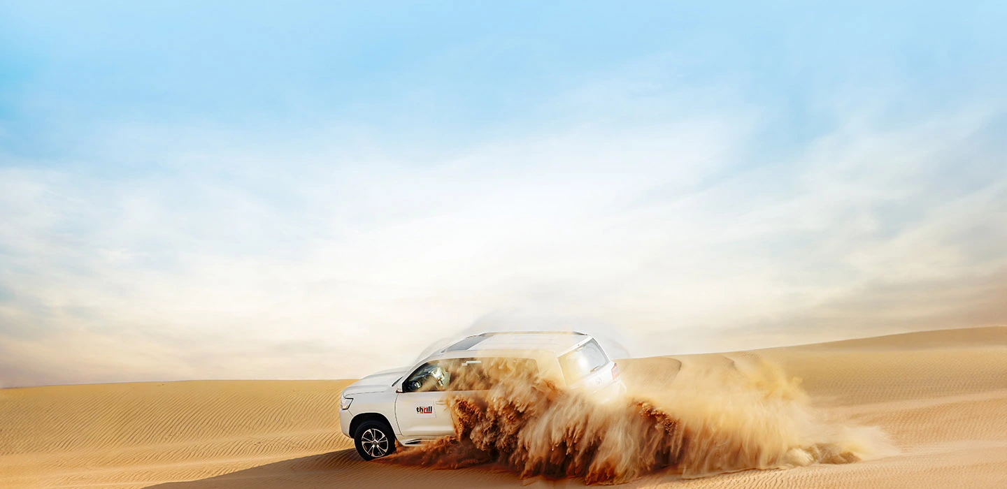 Desert Safari Dubai with 4x4 SUV dune bashing through golden sand dunes