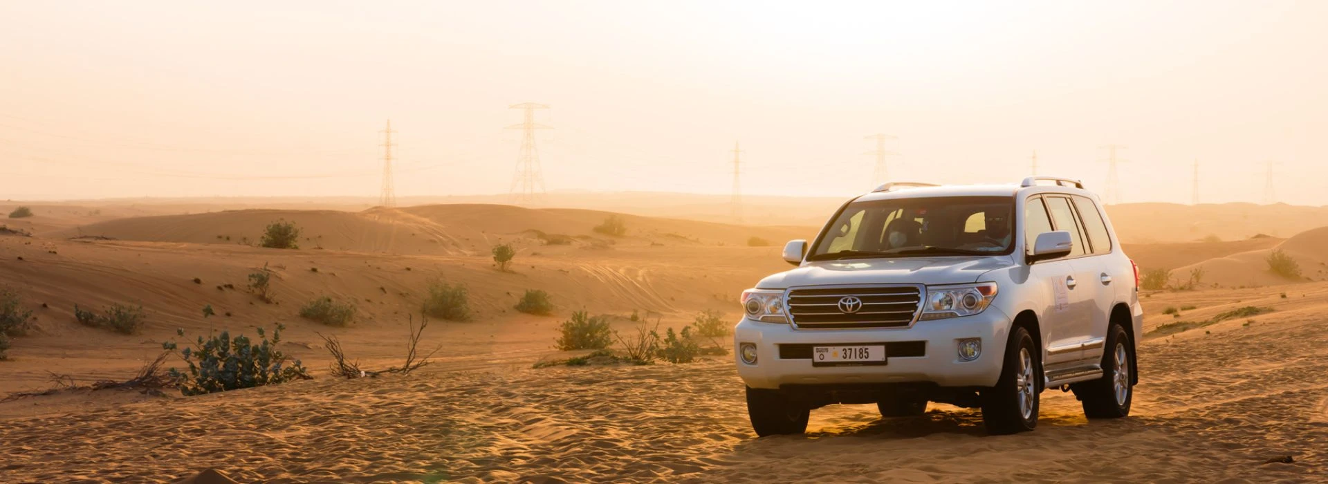 Evening desert safari in Dubai with Toyota Land Cruiser on sand dunes