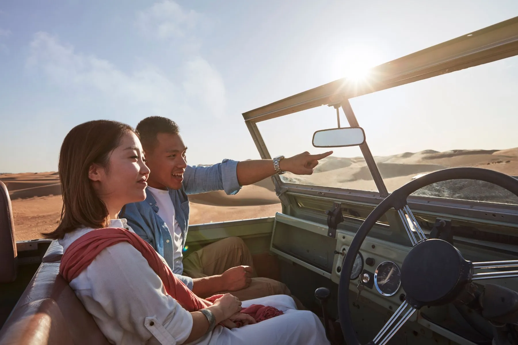 Couple enjoying an open top ride during overnight desert safari in Dubai