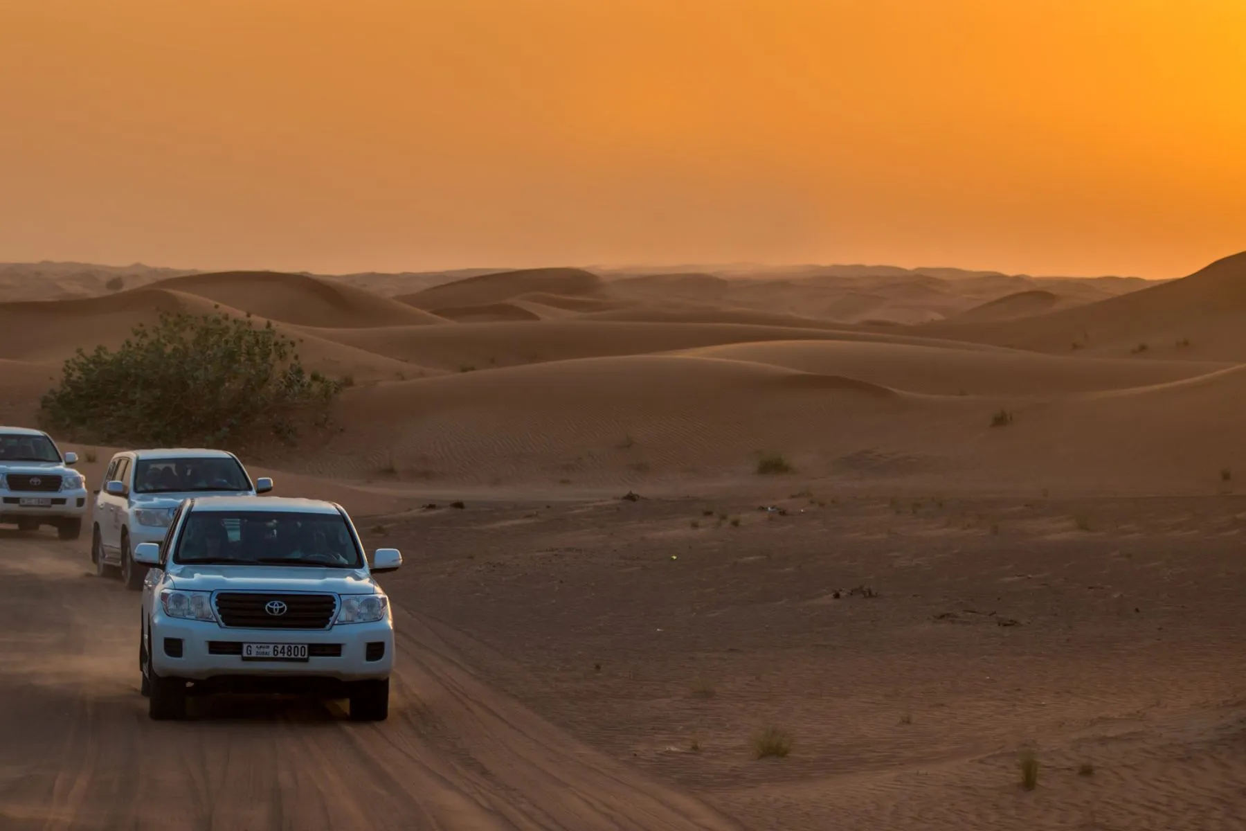 Couple enjoying an open top ride during overnight desert safari in Dubai