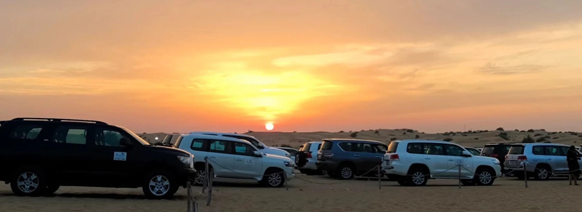 Jeeps alligned on Sunrise Hour in the desert Dubai